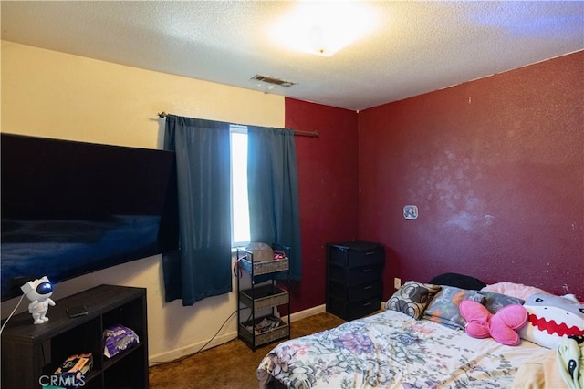 carpeted bedroom with a textured ceiling