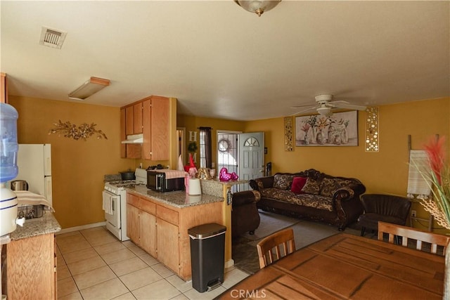 kitchen featuring ceiling fan, light tile patterned floors, white appliances, and stone counters