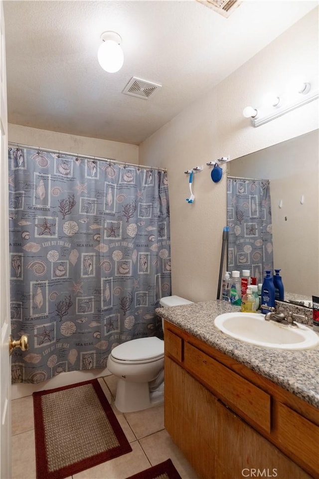 bathroom featuring tile patterned floors, vanity, and toilet