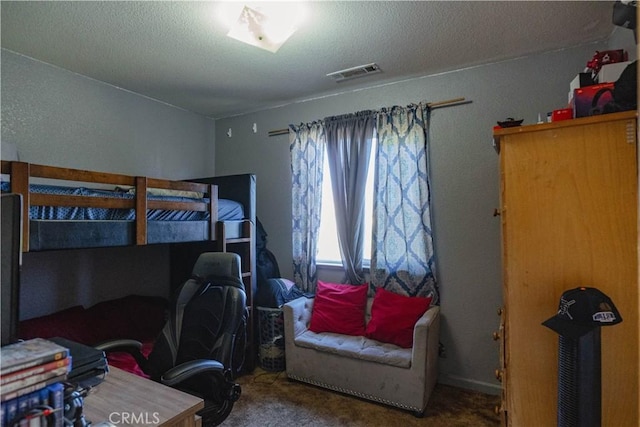 carpeted bedroom featuring a textured ceiling