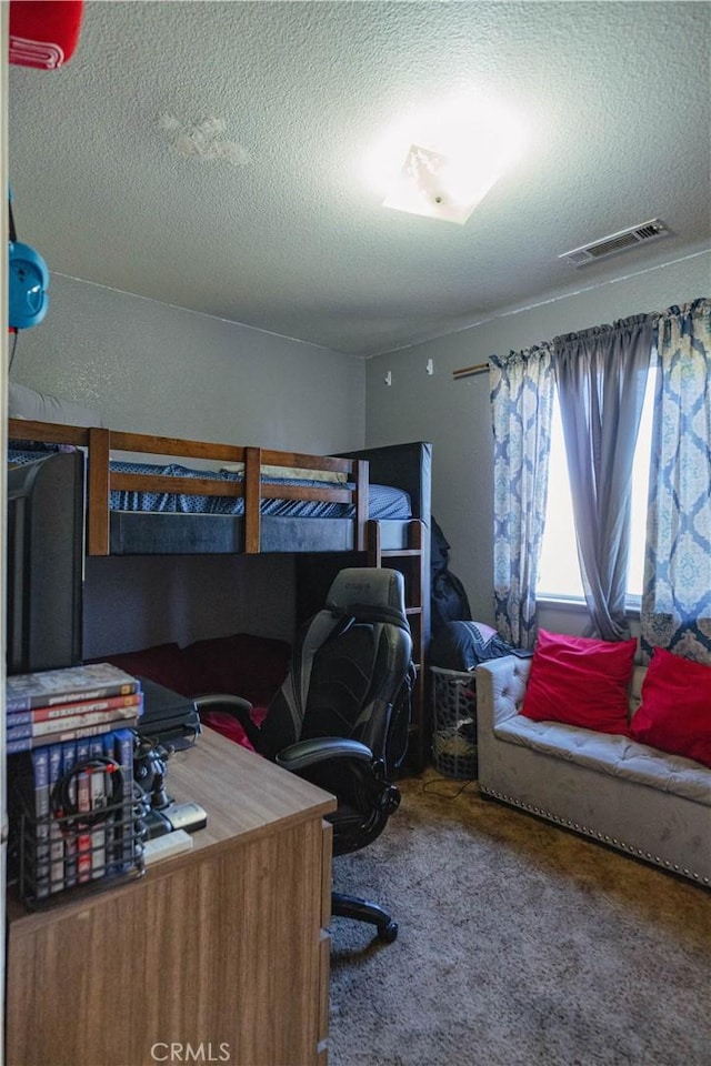 carpeted bedroom with a textured ceiling