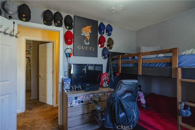 carpeted bedroom featuring a textured ceiling