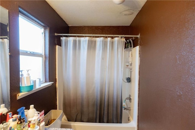 bathroom with shower / bath combo with shower curtain