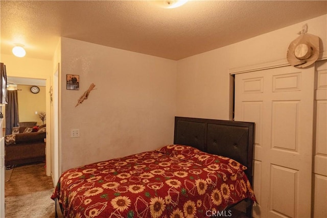 bedroom featuring a textured ceiling, a closet, and carpet flooring