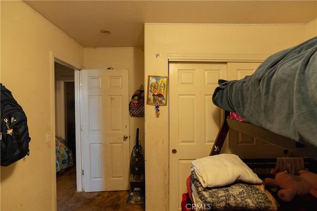 bedroom with a closet and dark colored carpet