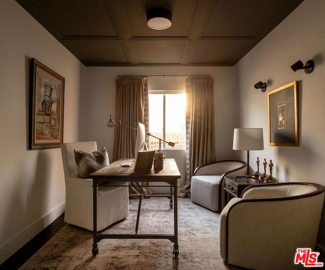 living area featuring coffered ceiling