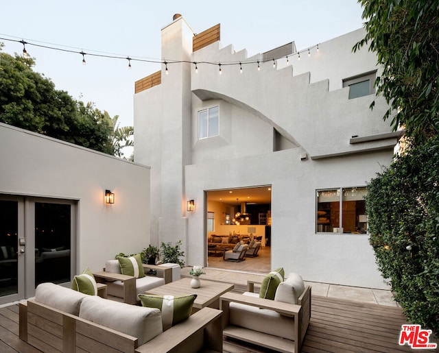 back of property with an outdoor hangout area