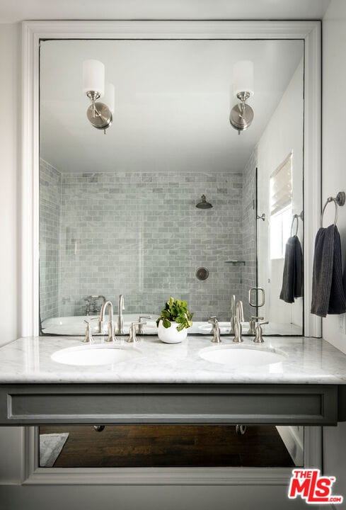 bathroom with vanity and a shower with shower door