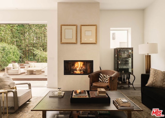 living room featuring a tile fireplace