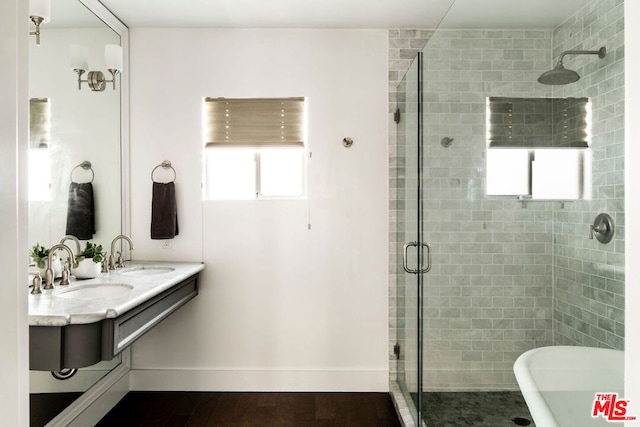 bathroom with vanity, hardwood / wood-style floors, and shower with separate bathtub