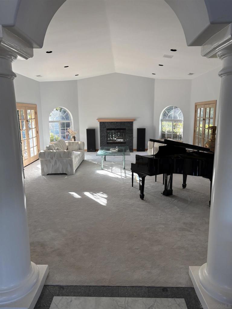 living room with french doors, carpet floors, and decorative columns