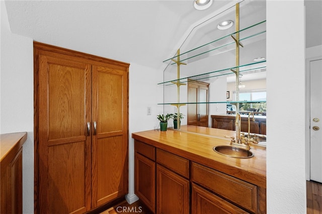 bathroom with vanity and vaulted ceiling