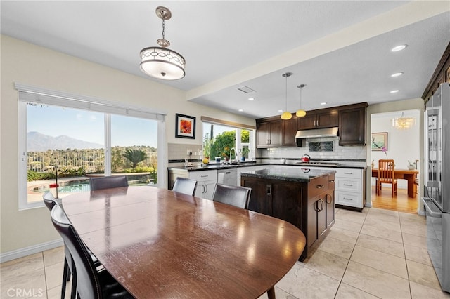 dining area featuring a mountain view and light tile patterned floors