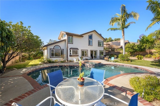 view of swimming pool featuring an in ground hot tub and a patio