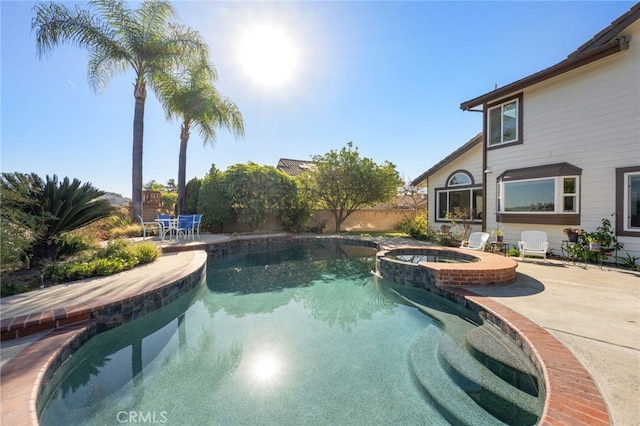 view of pool featuring an in ground hot tub and a patio