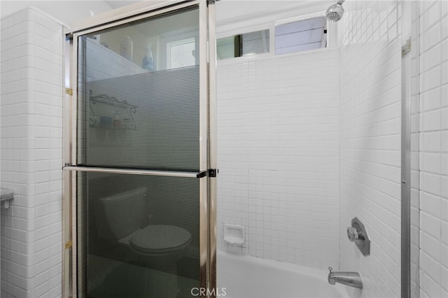 bathroom with shower / bath combination with glass door