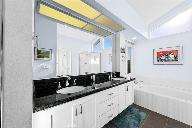 bathroom featuring vanity, plus walk in shower, and tile patterned flooring