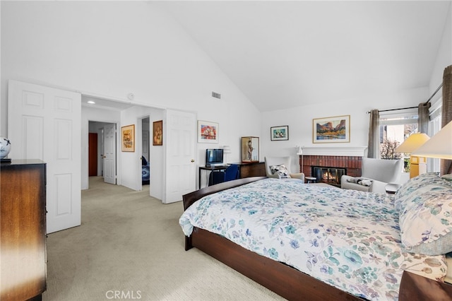 carpeted bedroom with high vaulted ceiling and a fireplace