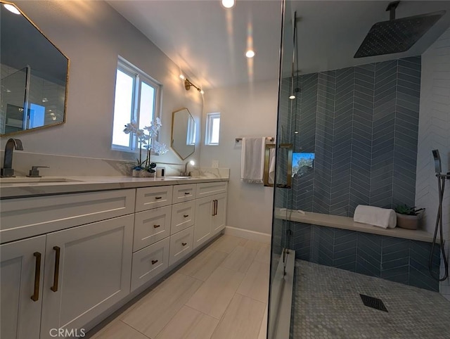 bathroom featuring vanity and a shower with door