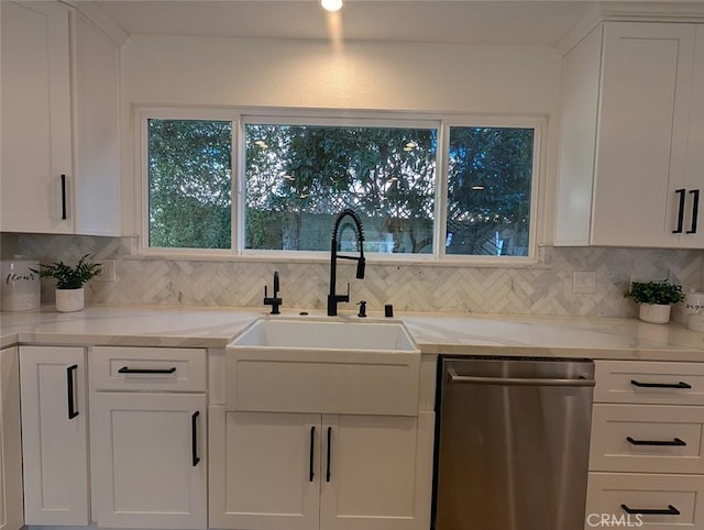 kitchen with light stone counters, white cabinetry, dishwasher, and tasteful backsplash