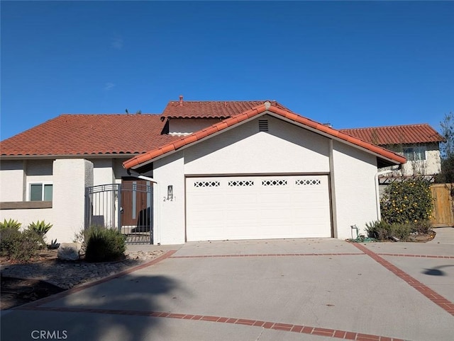 mediterranean / spanish-style home featuring a garage