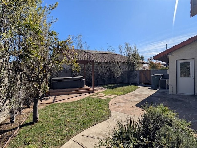 view of yard featuring a patio area and a hot tub