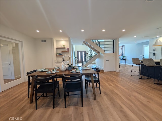 dining space with light hardwood / wood-style floors and plenty of natural light