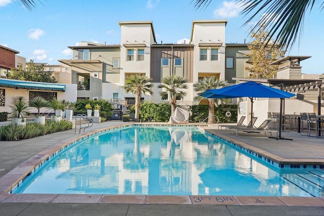 view of swimming pool with a pergola and a patio