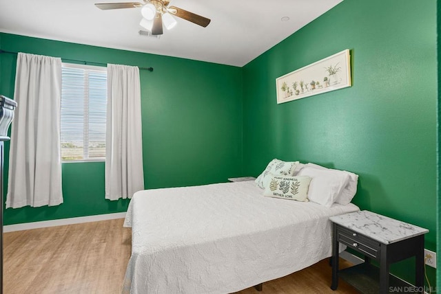 bedroom with ceiling fan and light hardwood / wood-style flooring