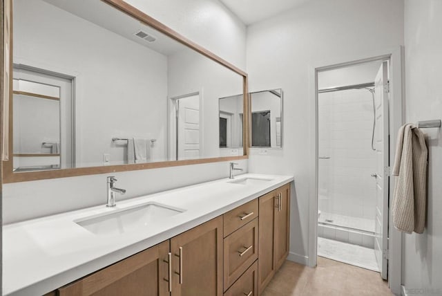 bathroom with tile patterned flooring, an enclosed shower, and vanity