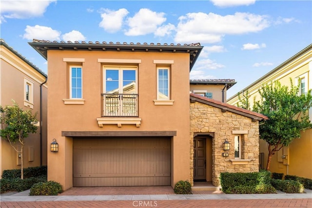 mediterranean / spanish-style home with a garage