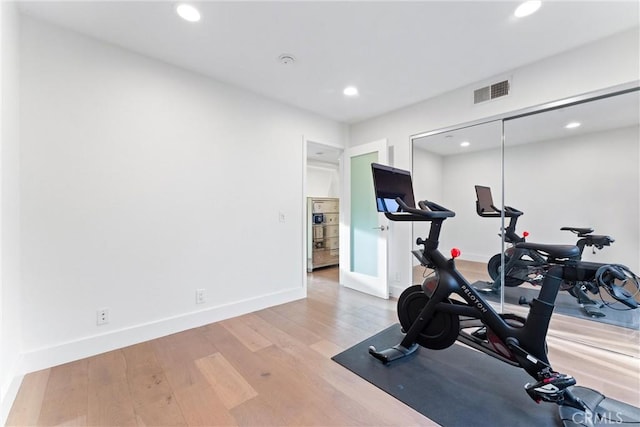 workout area featuring light hardwood / wood-style flooring