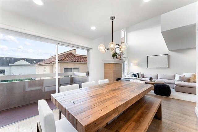 dining room with light hardwood / wood-style floors and a chandelier