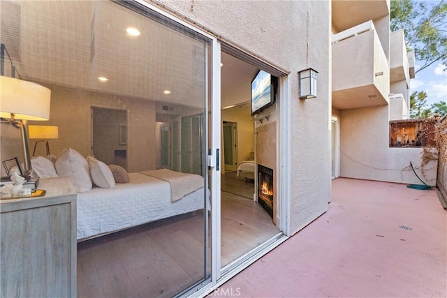 bedroom featuring exterior fireplace