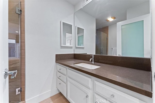 bathroom featuring vanity and a shower with shower door