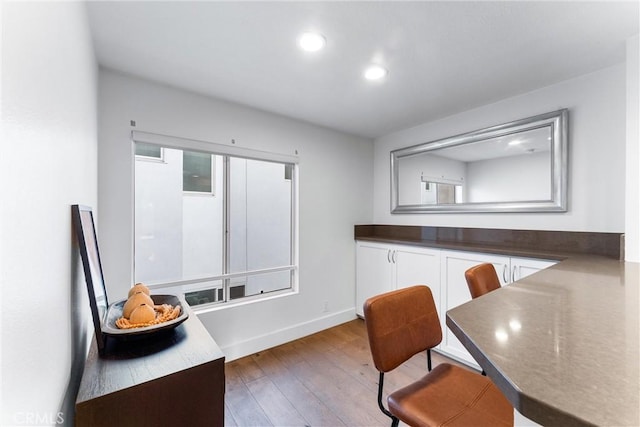 kitchen featuring dark wood-type flooring and white cabinetry