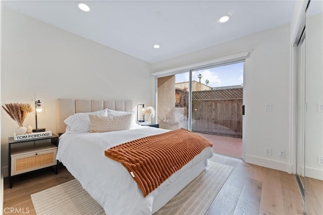 bedroom featuring access to exterior and hardwood / wood-style floors