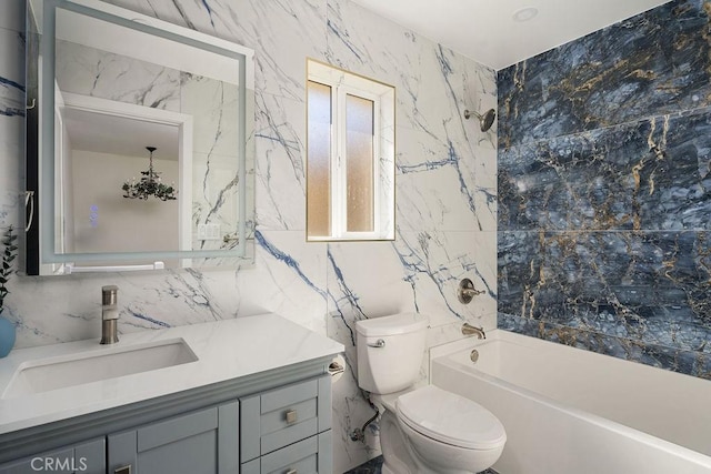 full bathroom featuring toilet, tile walls, shower / washtub combination, and vanity