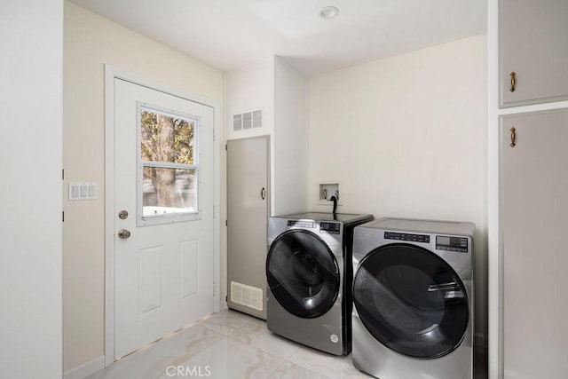 laundry area featuring washing machine and clothes dryer