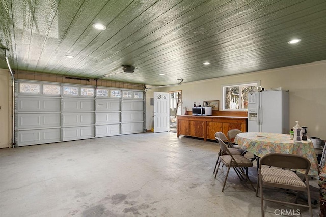 garage featuring white fridge with ice dispenser