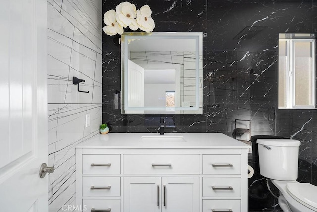 bathroom featuring tile walls, toilet, and vanity