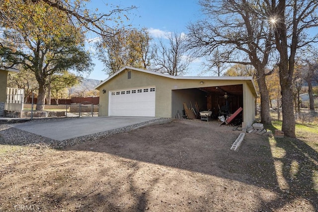 view of side of property with a garage and an outbuilding