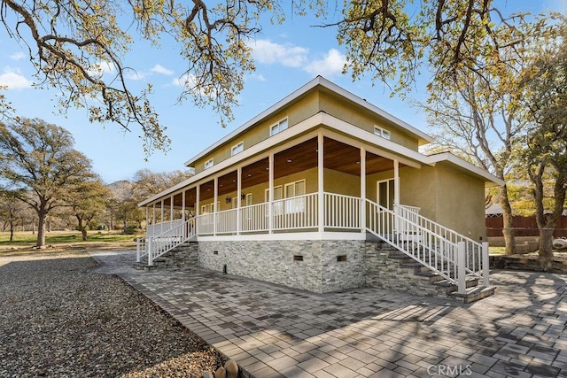 6124 Juniper Rd, Lake Isabella, CA 93240 - view of front of property featuring stucco siding, covered porch, and stairway