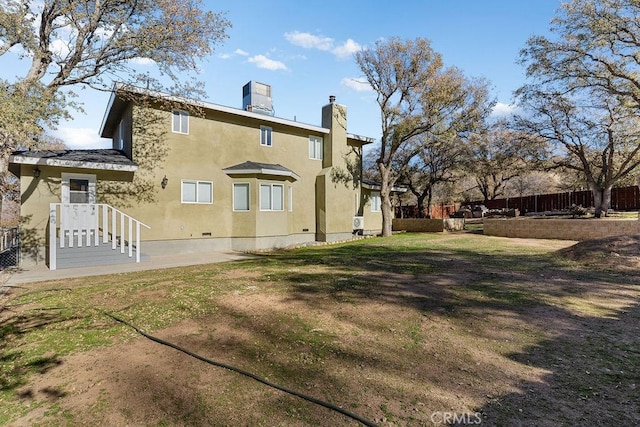 back of house featuring a yard