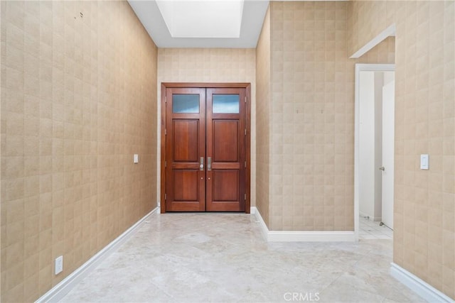 foyer entrance with a skylight