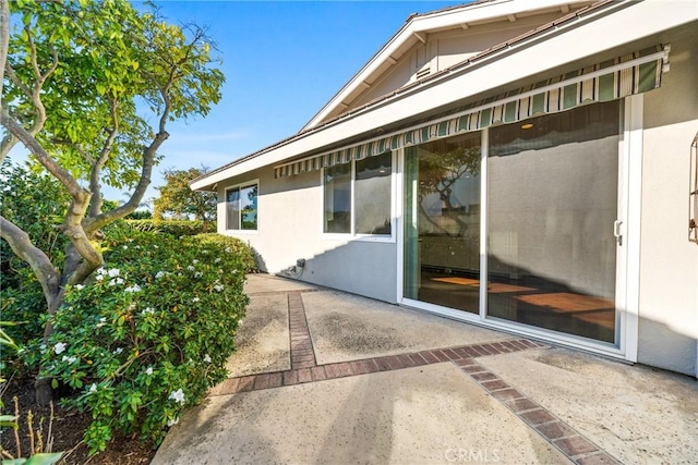 view of side of property with a patio area