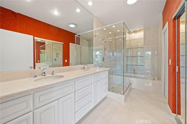 bathroom with tile patterned floors, vanity, and independent shower and bath