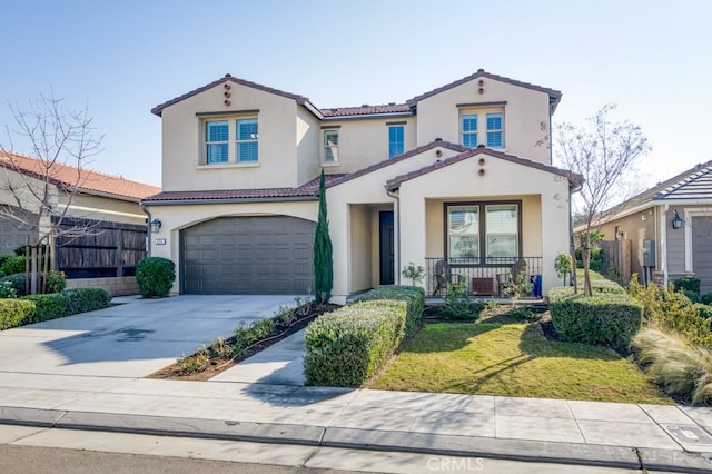 mediterranean / spanish-style home featuring a front lawn, a garage, and a porch