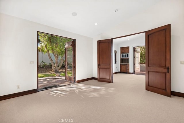 unfurnished room with light colored carpet