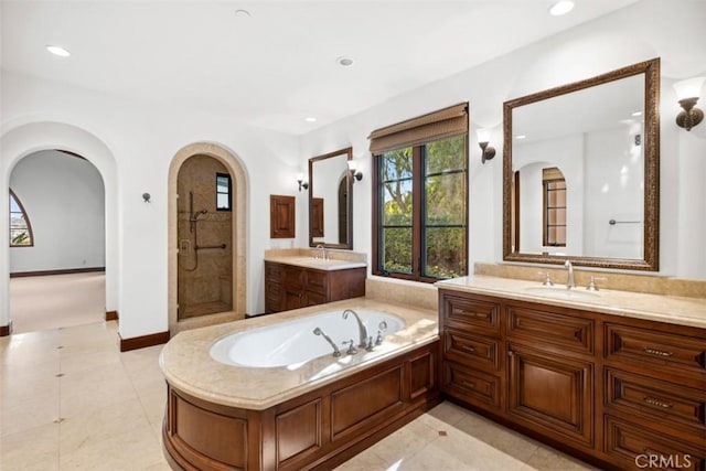 bathroom featuring tile patterned floors, vanity, and separate shower and tub